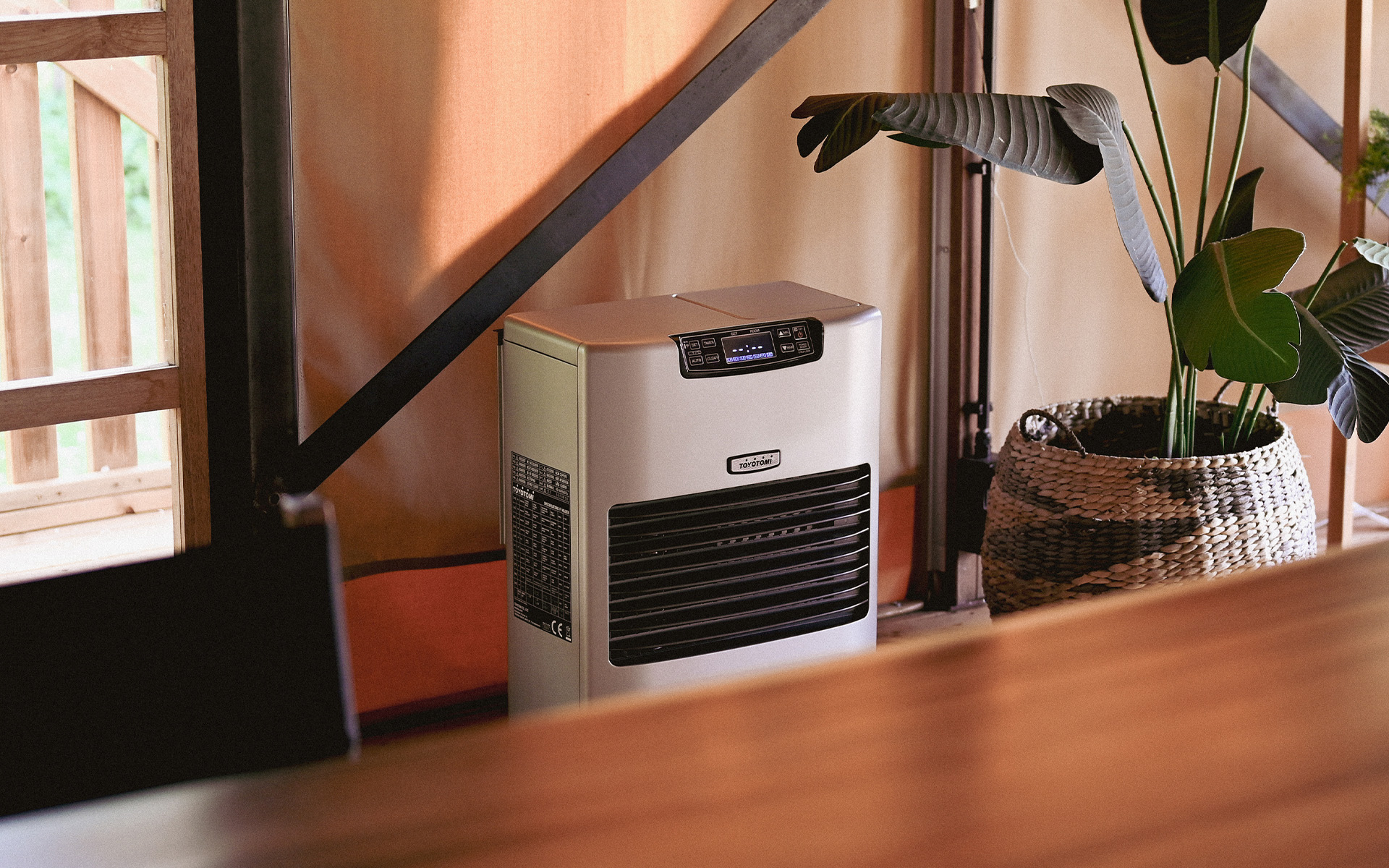 Toyotomi FF-55 paraffin heater operating inside a glamping tent, providing warmth and comfort to the room.