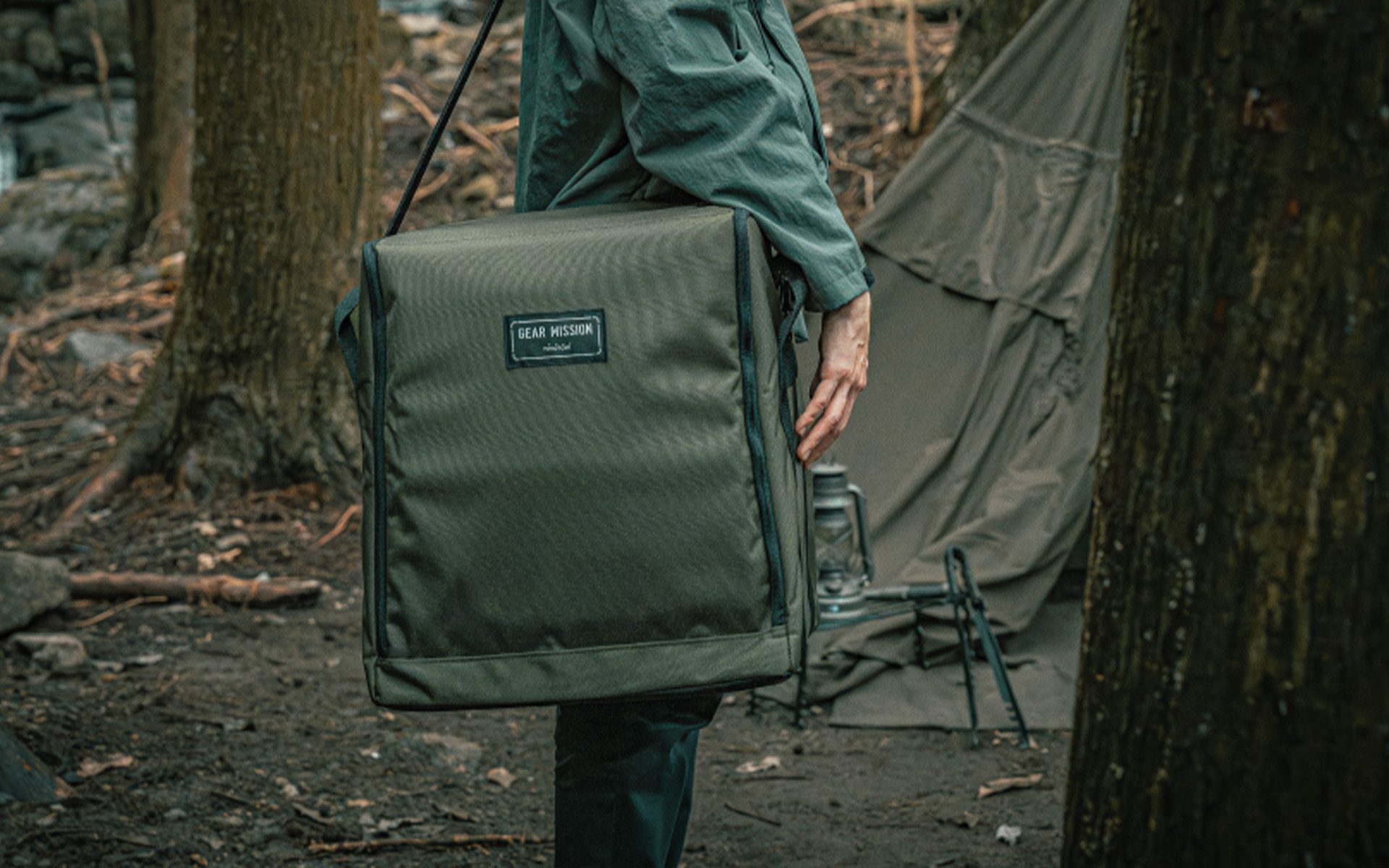 Person carrying Toyotomi GEAR MISSION heater bag over shoulder, showcasing easy portability for outdoor and indoor use.