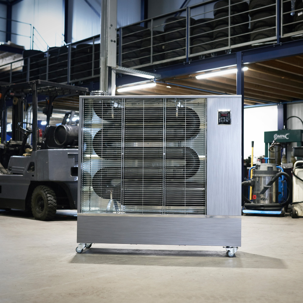 Toyotomi Europe Infrared heater heating a garage full of cars.