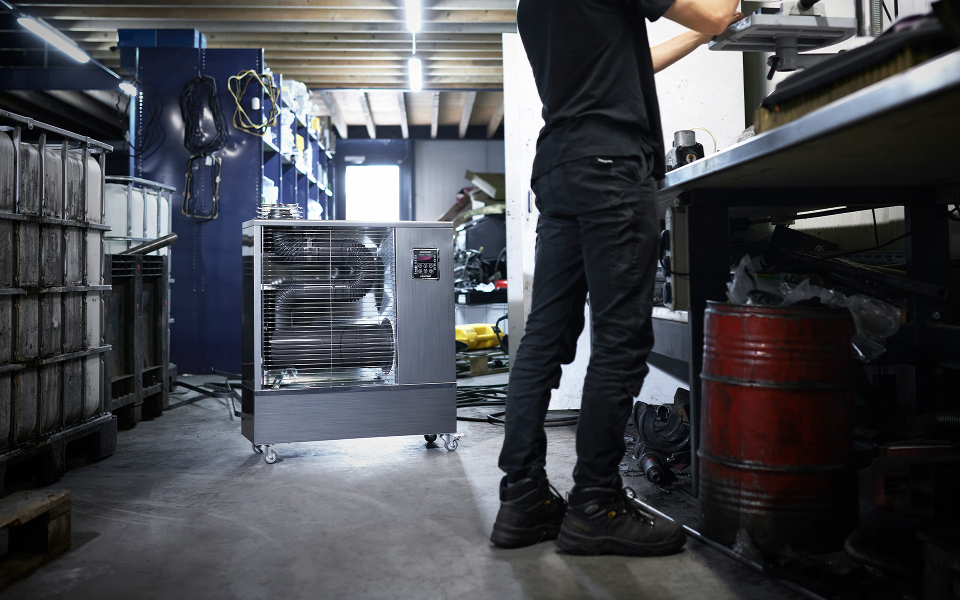 Toyotomi Infrared Heater TIB-09 delivering targeted warmth to a mechanic working in a workshop, ensuring comfort and efficiency.