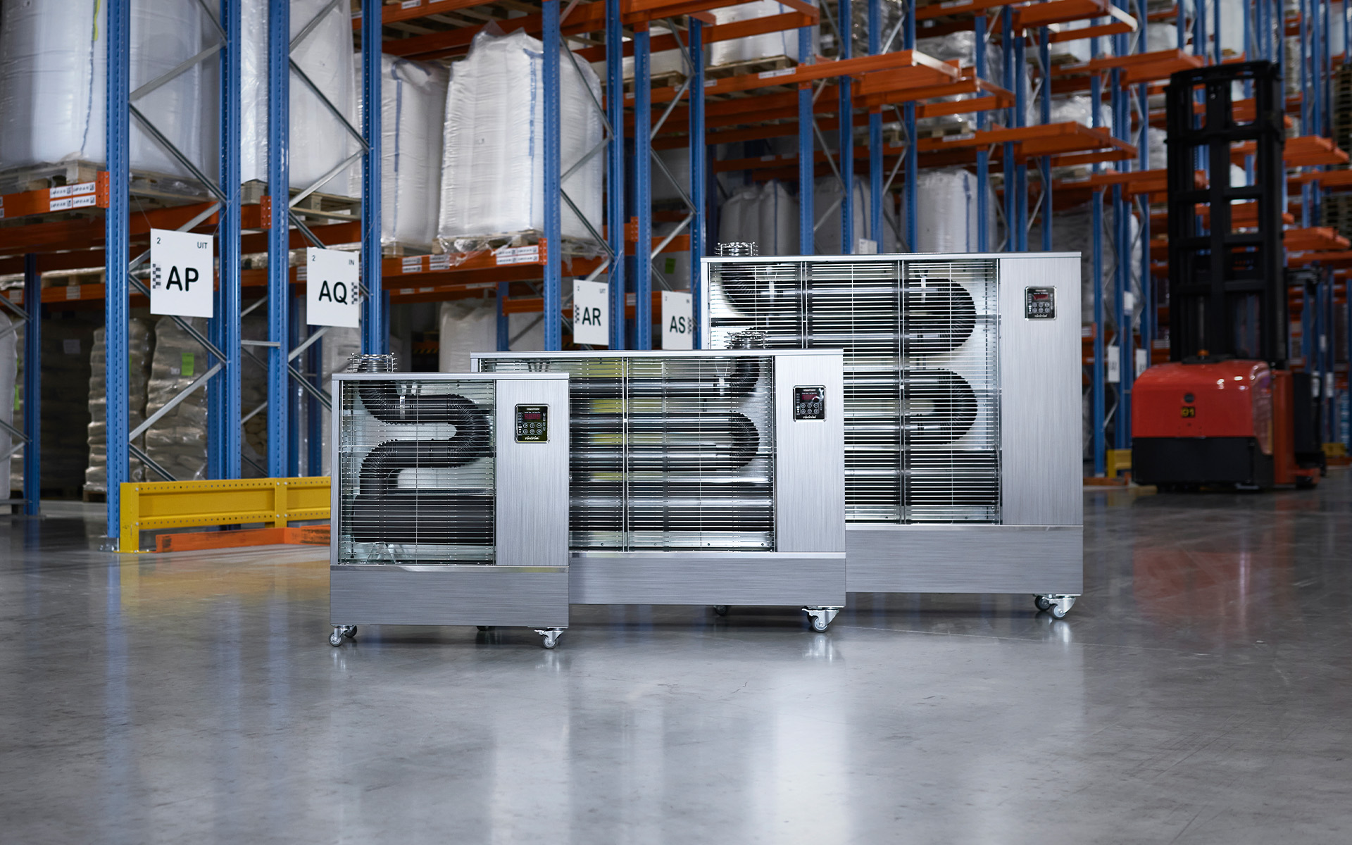 Complete range of Toyotomi infrared heaters displayed in a spacious warehouse, showcasing industrial-grade heating solutions.