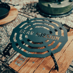Portable grill with "Gear Mission" branding, ideal for outdoor cooking and camping adventures.
