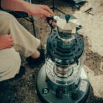 Outdoor patio heater with adjustable control knob and protective cage.