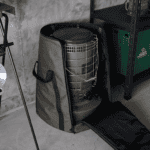 Portable heater stored in a protective carrying case for easy transport.