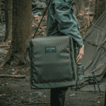 Large green gear bag for outdoor camping and travel needs.